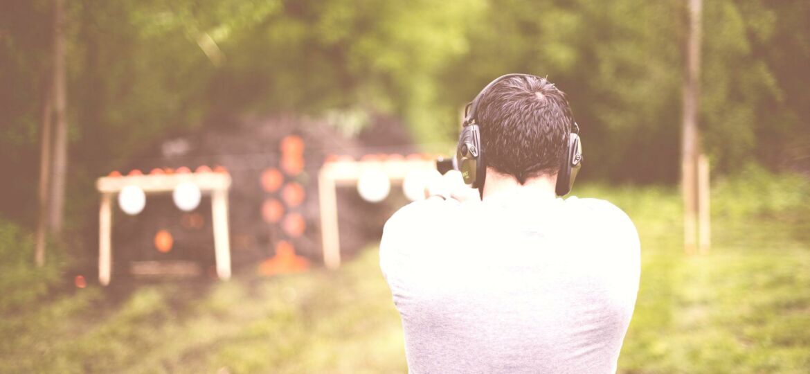 shallow-focus-shot-from-male-shooting-gun-gun-range-scaled-washed