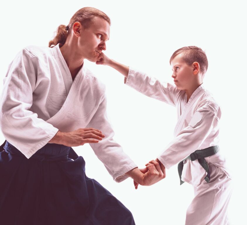 man-teen-boy-fighting-aikido-training-martial-arts-school-healthy-lifestyle-sports-concept-fightrers-white-kimono-white-wall-scaled-tender